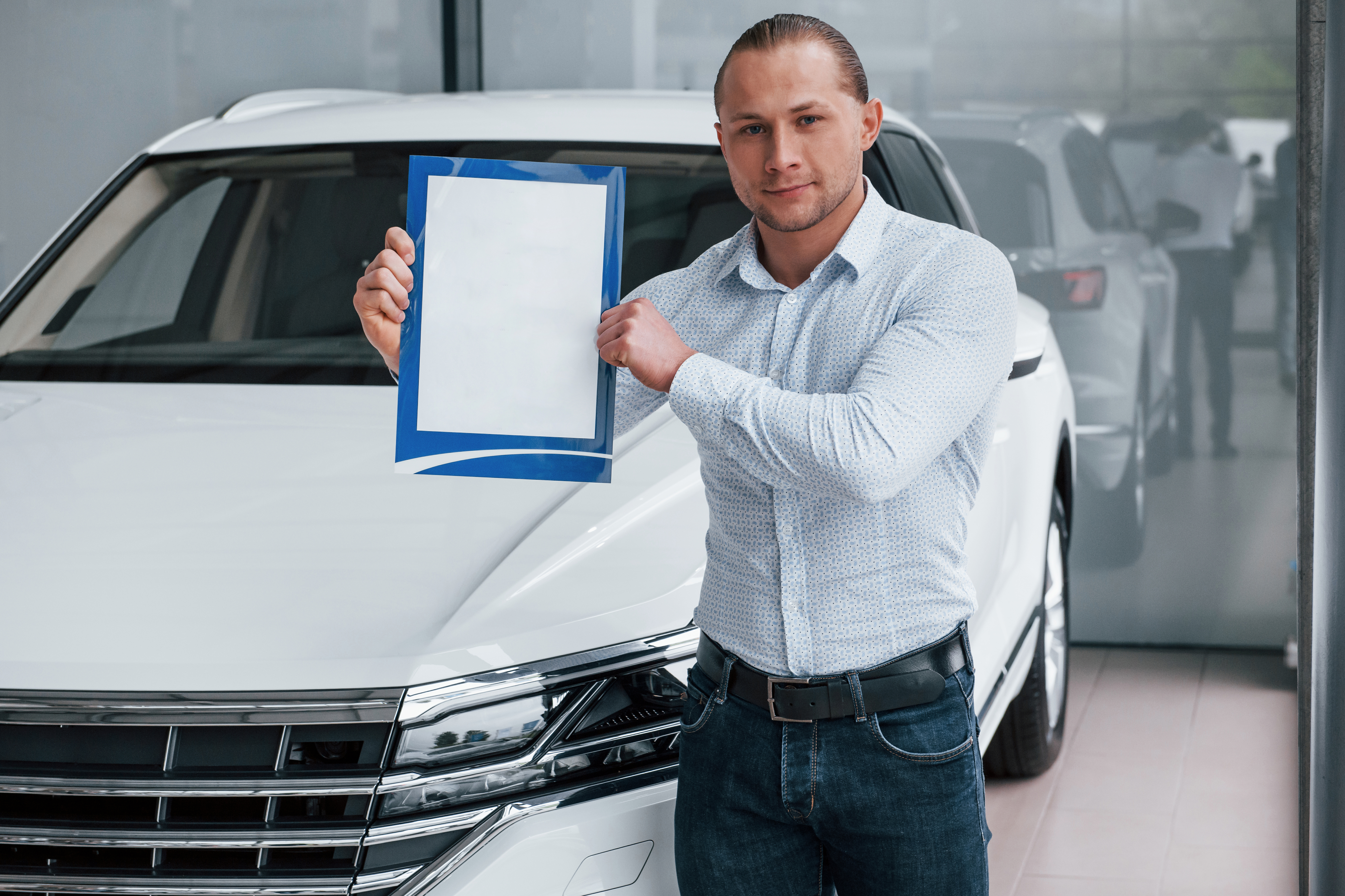 important-document-manager-stands-front-modern-white-car-with-paper-hands.jpg